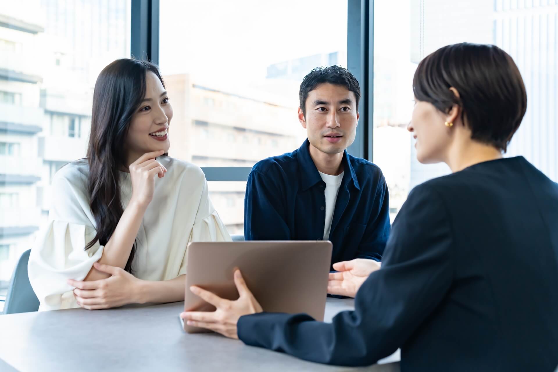 会議で意見交換をする三人の参加者